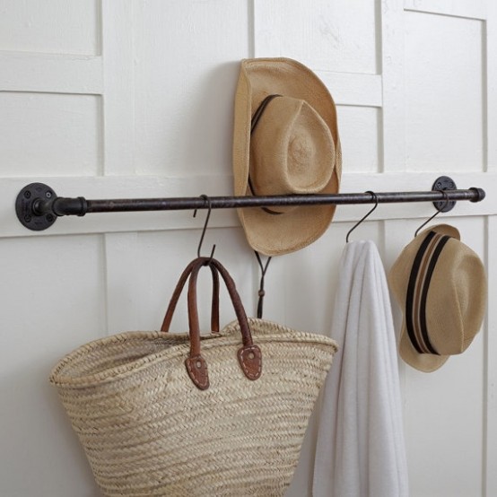 a small and cool black pipe rack for hats and for hanging bags is a great idea for a closet, a bedroom or some other spaces