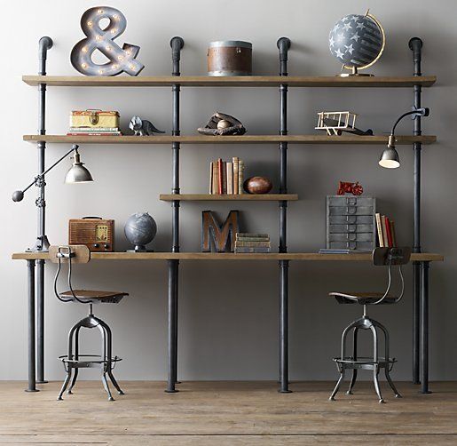 a large pipe shelving unit with stained shelves and desks, with various decor can fulfill a function of a shared study-work space
