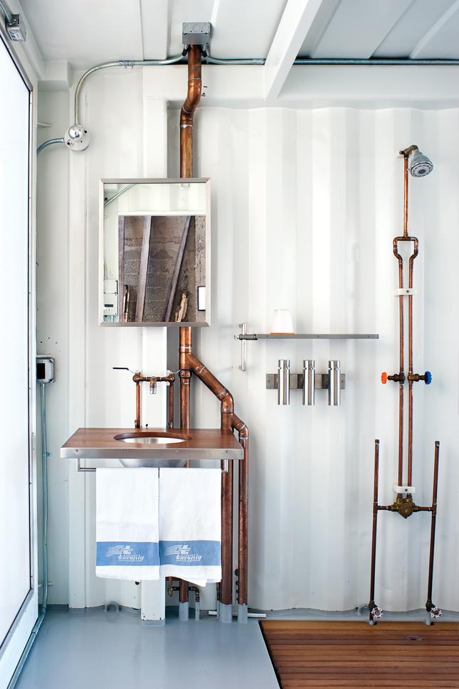 an industrial bathroom with all pipes exposed that become part of decor, not just pipes is a lovely space to be in