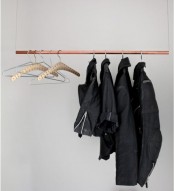 a very simple pipe clothes rack like this one can be made of a copper pipe on some twine or rope and some clothes hangers, a smart DIY solution