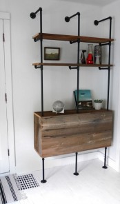 a shelving and storage unit of black pipes and reclaimed wood is a lovely idea for an awkward nook, it’s a smart solution