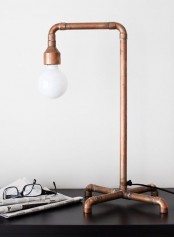 a copper pipe table lamp is a unique idea and a lovely way to add an industrial feel to the space