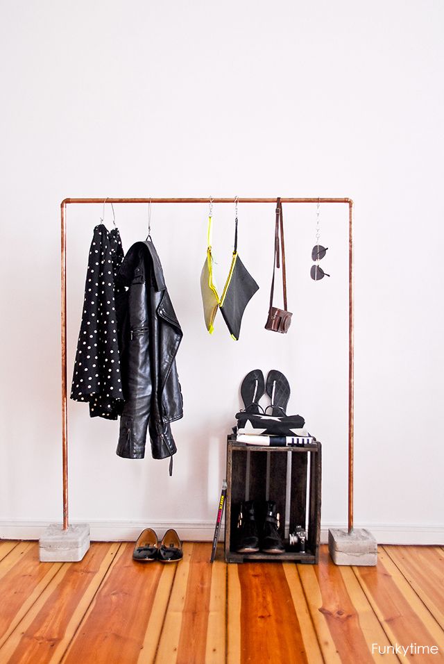 a copper pipe closet rack with a concrete base is a lovely idea for any entryway with a more modern feel