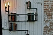 a large black pipe shelving unit with bulbs is a smart and cool idea for an industrial space, and not only