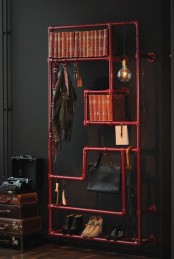 a creative storage unit built of red pipes is suitable for shoes, clothes, umbrellas, books and much other stuff you may want to store and display