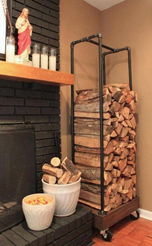 a built in fireplace with a black brick surround and a black pipe firewood stand next to it are a cool combo for a modern farmhouse space