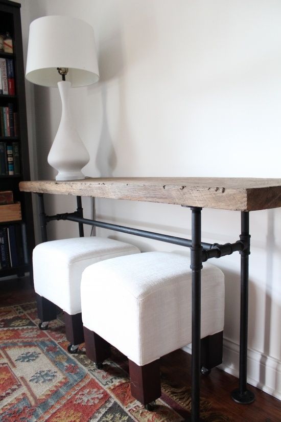 a chic industrial console table with piep legs and a wooden slab on top is a lovely idea for an entryway