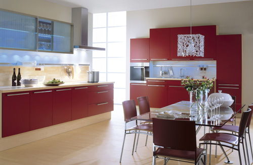 a bold red kitchen with neutral backsplashes and lots of lights plus catchy lamps is very cool