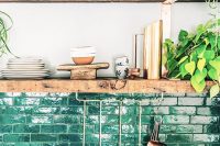 a brick backsplash painted green is a catchy and bold idea for a modern kitchen, it adds color and interest to the space