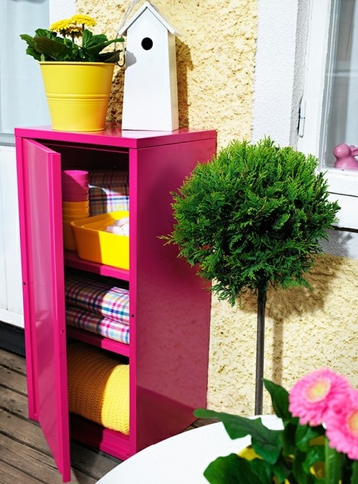 a bright pink cabinet for storage is a cool idea if you have not a veyr tiny balcony