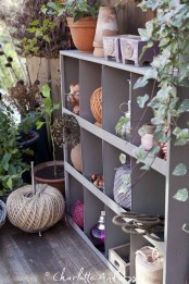 a grey metal shelving unit for storage is a cool idea for a balcony but it requires some space