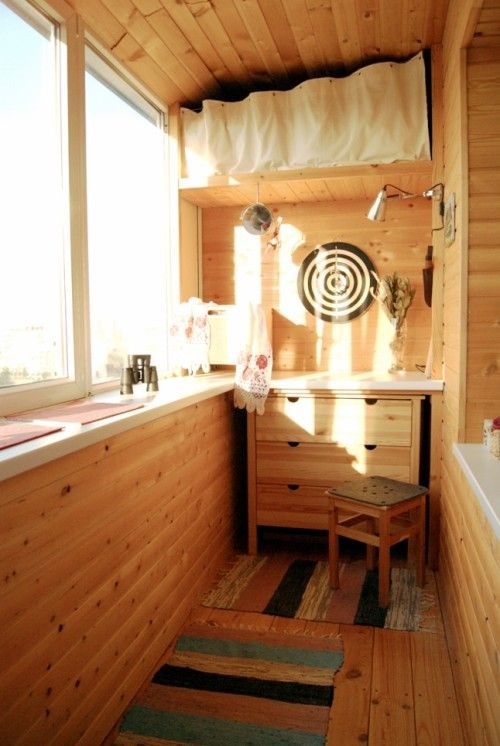 a small sideboard and a shelf with with a curtain over it for storage in a small space