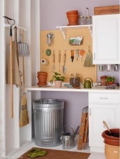white cabinets to declutter and a pegboard for hanging some stuff you need often