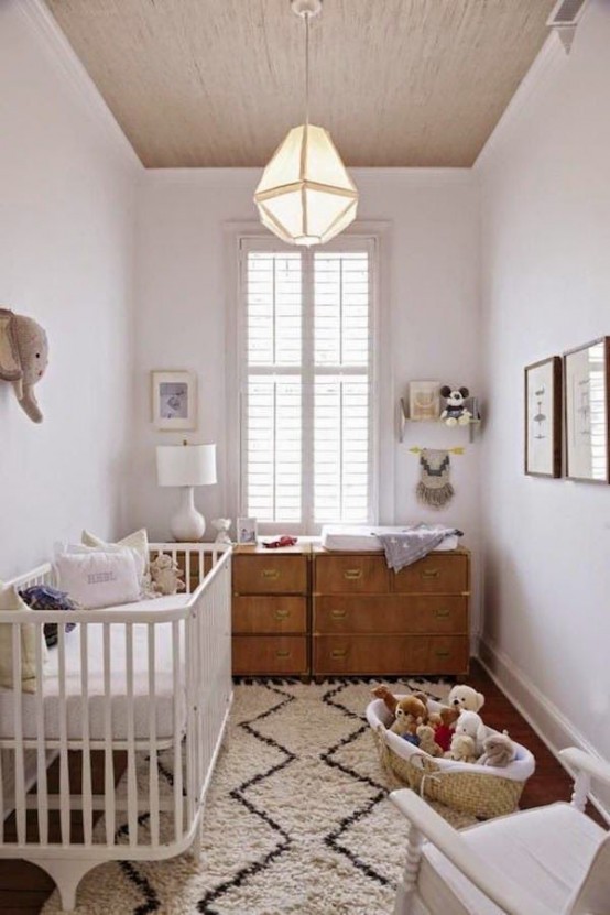 a neutral mid-century modern nursery with a stained dresser, a white crib, a printed rug and some toys in baskets is a cool idea