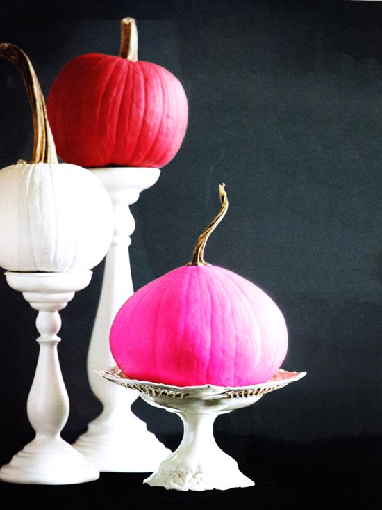 a white, red and pink pumpkin on a stand are bold and non-typical fall decorations for a modern home