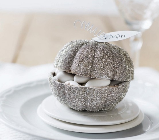 a silver glitter pumpkin with white candies inside is a lovely idea for a fall, Thanksgiving or white Halloween celebration