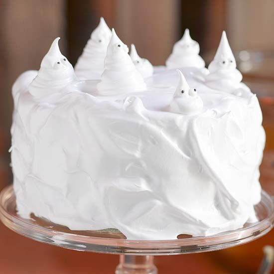 a fun white buttercream wedding cake topped with white meringue ghosts is a very fresh and bold idea