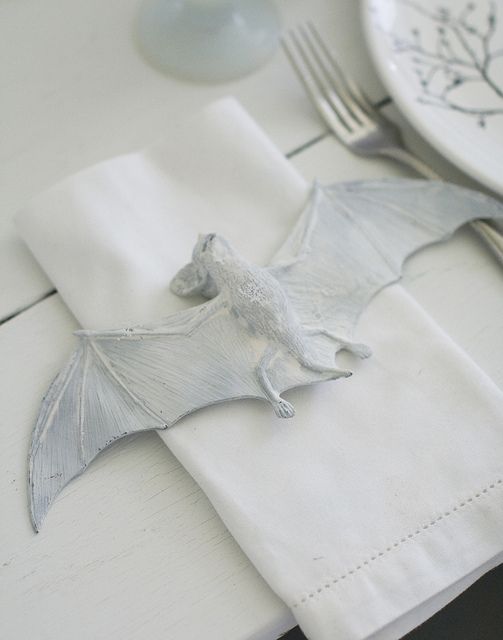 a white napkin decorated with a white bat looks scary and bold and the bat is pretty realistic, try that for your Halloween party
