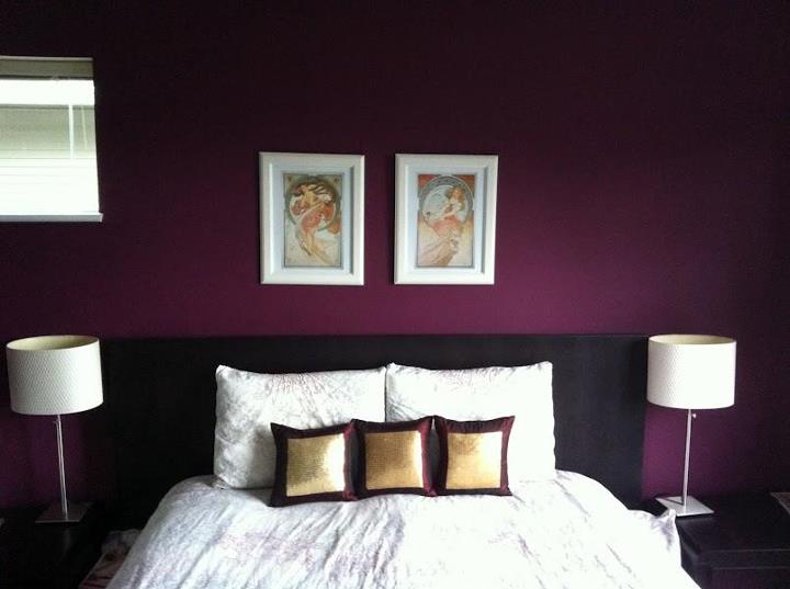 a purple accent wall will be a bold color statement for a monochromatic bedroom like this one