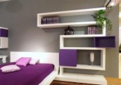 a minimalist white and purple bedroom with a bed, a shelving unit, some greenery and lights is a stylish space with nothing excessive