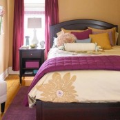 a buttermilk bedroom with dark stained furniture, with purple touches and textiles and buttermilk pillows feels welcoming