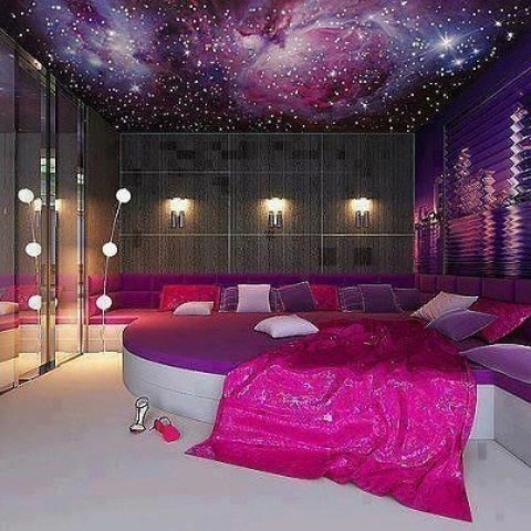 a contemporary bedroom with a half circle bed, a galaxy ceiling and quirky lights, with purple and pink touches