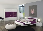 a white and purple bedroom with sleek minimalist furniture, a statement artwork, purple and white bedding and table lamps