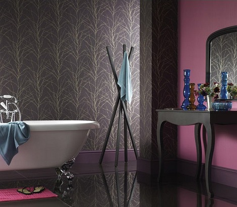 a dramatic and moody purple bathroom with dark furniture, a vintage clawfoot bathtub and a statement wall with printed wallpaper