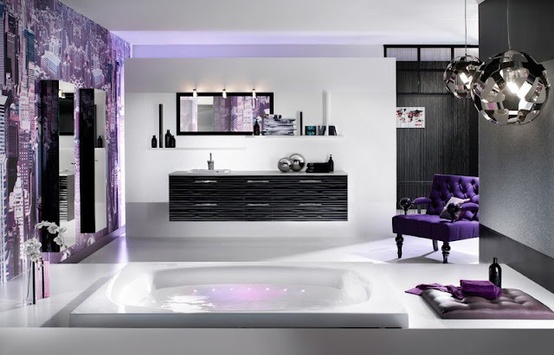 a bright eclectic bathroom with pendant sphere lamps, a purple statement wall and a chic purple chair plus lavender touches