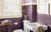 an elegant purple, lavender and creamy bathroom with touches of wood and simple appliances