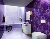a super bright purple and lavender bathroom clad with various types of tiles including floral ones, elegant lighting and sculptural vanities