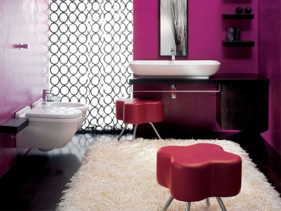 a bright contemporary space done with fuchsia, purple, black and white, leather poufs, a printed curtain and black furniture