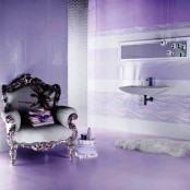 a whimsical purple bathroom with an elegant vintage chair, a beaded curtain, bubble pendant lamps and a floating sink