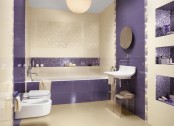 a bold modern bathroom in purple and neutrals, with smaller and larger scale tiles, niches and floating appliances