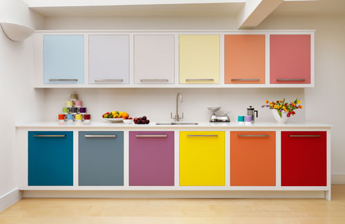 a contemporary rainbow kitchen with cabinets done in bold mismatching shades and uppers in more muted shades looks just jaw-dropping