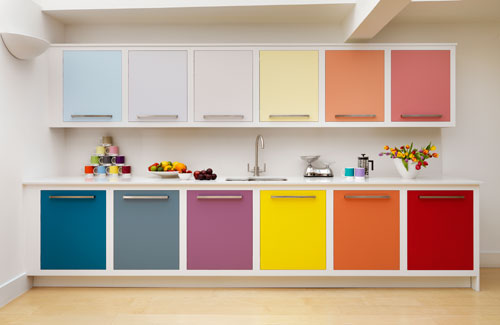 a contemporary rainbow kitchen with cabinets done in bold mismatching shades and uppers in more muted shades looks just jaw-dropping