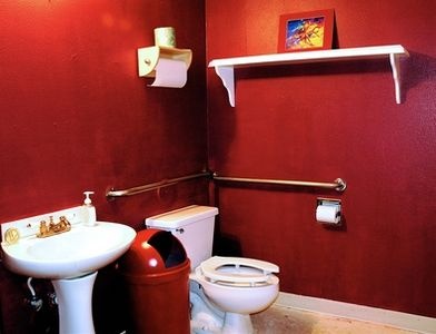 a mini mudroom in red, with white appliances, shelves and other stuff looks bold and very cool