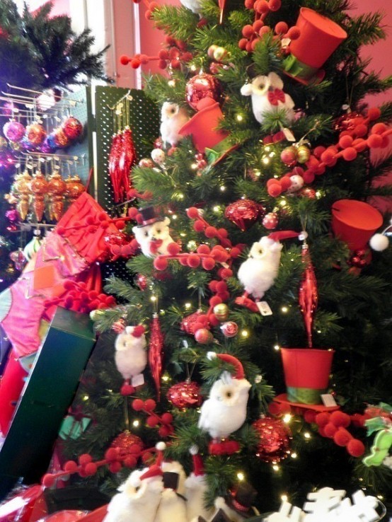 a Christmas tree decorated with lights, red pompoms, red top hats, white owls is a fun and cool idea suitable for a kids' room