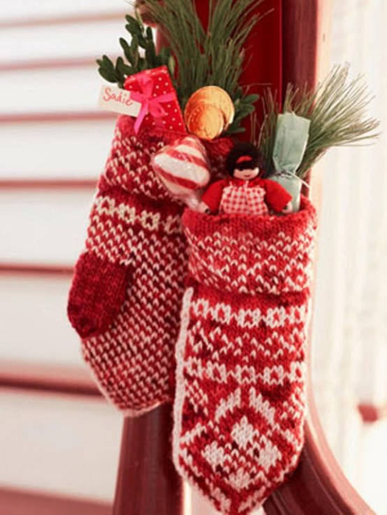 red and white mittens filled with evergreens, candies and dolls can be a nice decoration and an alternative to traditional Christmas stockings