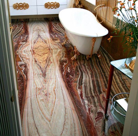 a vintage bathroom done with an onyx floor, a vintage bathtub, gold and brass touches to make the space more luxurious