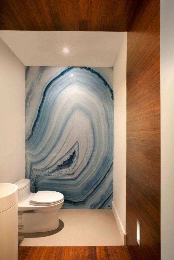 a luxurious contemporary bathroom in white and stained wood panels plus a blue onyx accent wall that brings a luxurious touch to the space