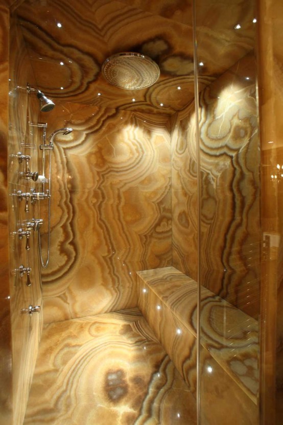 a luxurious shower space totally clad with onyx of warm tones is a gorgeous idea for a luxury home and it will welcome inside with its warm shades