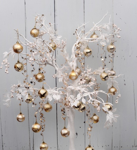 a white snowy Christmas tree with white fabric leaves and gold ornaments is a beautiful and refined alternative to a usual Christmas tree