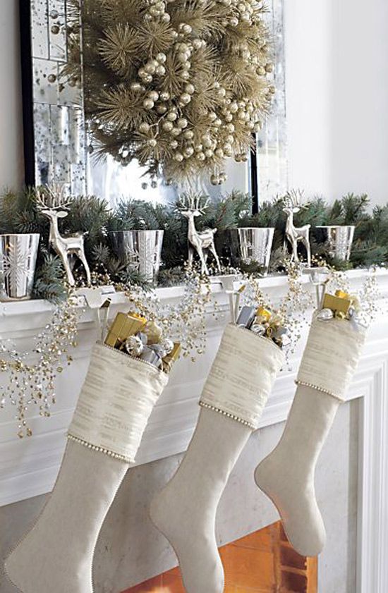 white Christmas stockings with gold and silver ornaments and branches, gift boxes, a gilded evergreen wreath with berries are beautiful and refined