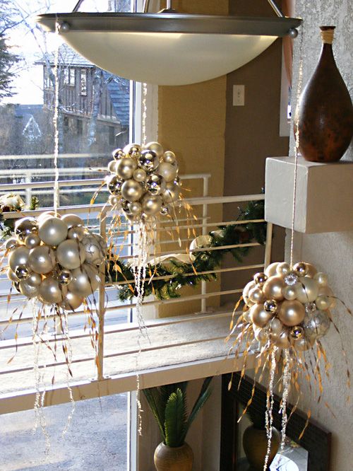 white, gold and silver Christmas ornament balls hanging over the space are amazing to style your home for the holidays