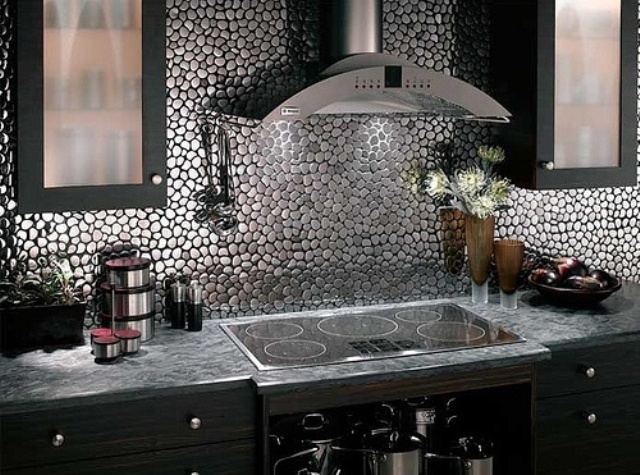 a modern and refined Gothic kitchen with dark cabinets, a metallic backsplash and stone countertops is lovely