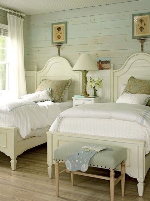 a vintage bedroom with whitewashed wooden walls, refined furniture, artworks and neutral linens is pure elegance
