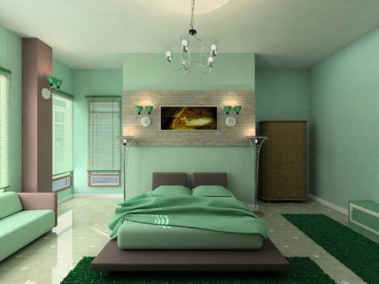 a green zen bedroom with brown touches, a platform bed, a green sofa, a wardrobe and a bench plus lights is a lovely idea