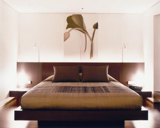 a beautiful zen bedroom with a dark Asian minimalist bed and nightstands, dark bedding and a lovely floral artwork