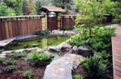 a Japanese garden with a pond, some shrubs and greenery and a couple of trees for a peaceful zen look